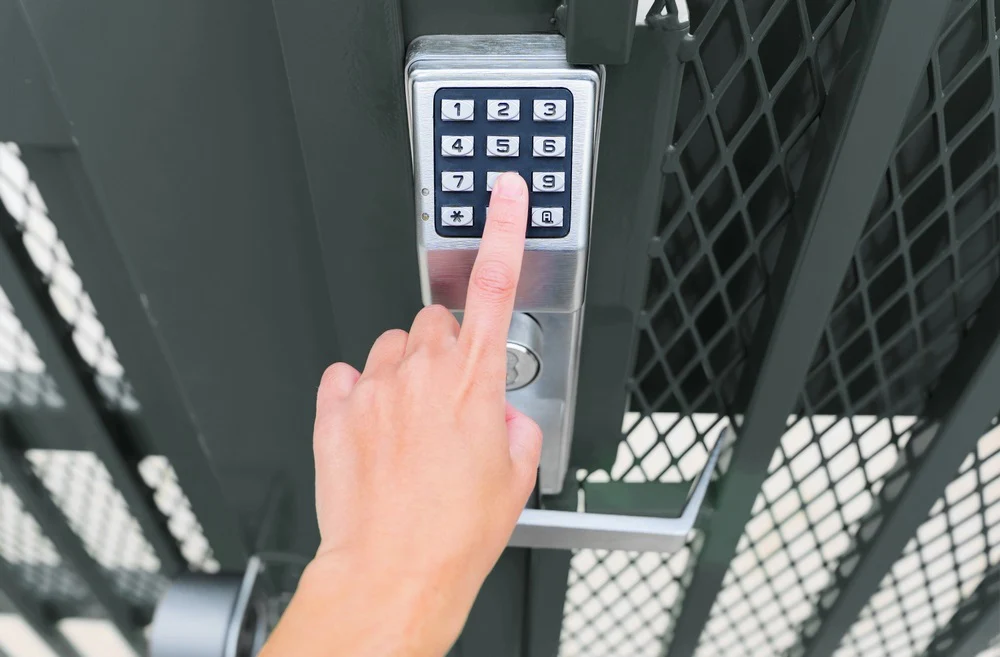 Wicket Gate Lock / Automation man enter a code to open a mechanical keypad gate lock